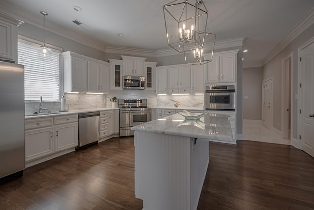 kitchen featuring dark hardwood / wood-style flooring, white cabinets, sink, and stainless steel appliances