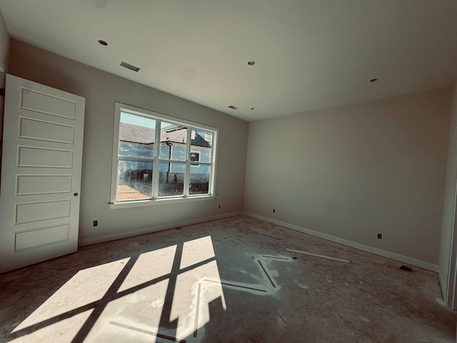 empty room with visible vents and baseboards