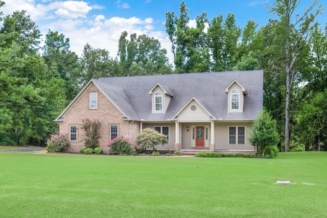 view of front of home featuring a front lawn and brick siding