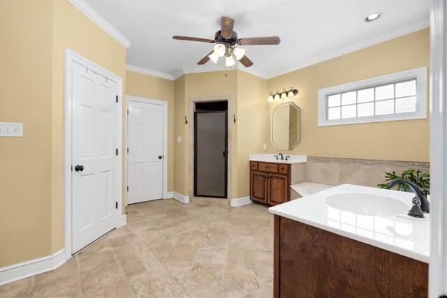 bathroom featuring ornamental molding, a sink, a shower stall, and baseboards