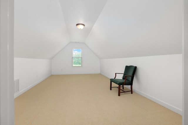 sitting room featuring lofted ceiling, carpet flooring, visible vents, and baseboards