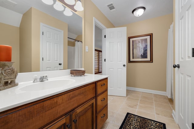 bathroom featuring tile patterned floors, vanity, visible vents, and baseboards