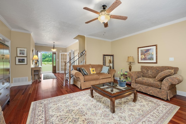 living area with visible vents, baseboards, stairs, ornamental molding, and dark wood finished floors