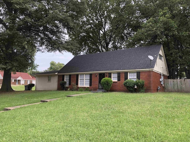 ranch-style house featuring a front yard, brick siding, fence, and roof with shingles