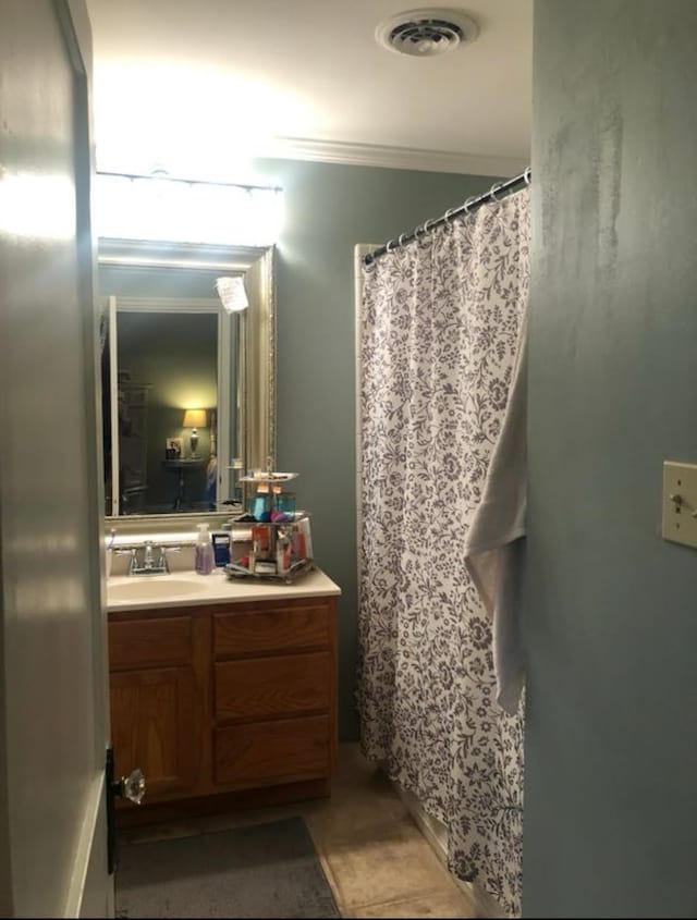 bathroom with tile patterned flooring and vanity