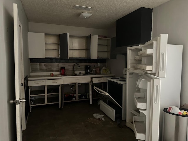 kitchen featuring electric range oven, sink, a textured ceiling, and white refrigerator