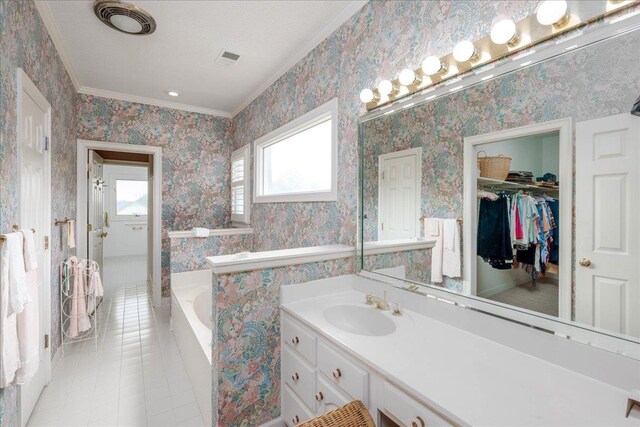 bathroom featuring tiled tub, tile patterned flooring, vanity, and ornamental molding