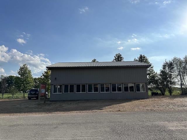 view of side of home featuring metal roof