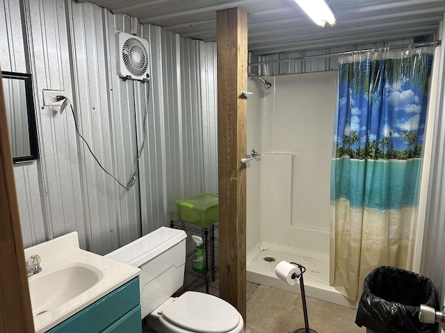 full bath with toilet, a stall shower, vanity, and wooden walls