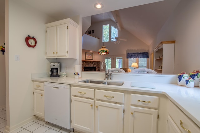 kitchen with lofted ceiling with beams, sink, a fireplace, light tile patterned floors, and white dishwasher