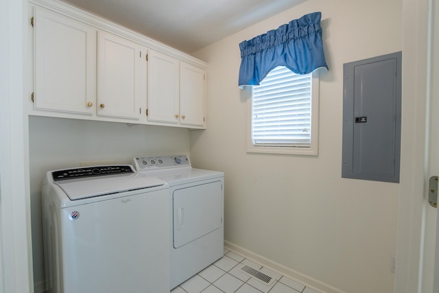 laundry area featuring washer and clothes dryer, electric panel, cabinets, and light tile patterned floors