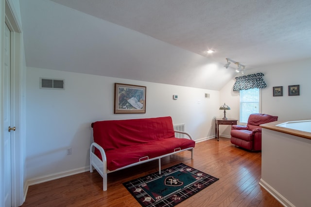 100 Vantage Pt, Counce, TN 38326 - living room featuring vaulted ceiling, a textured ceiling, baseboards, visible vents, and hardwood / wood-style floors