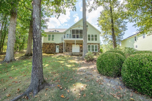 100 Vantage Pt, Counce, TN 38326 - rear view of house featuring a lawn, a sunroom, and stone siding