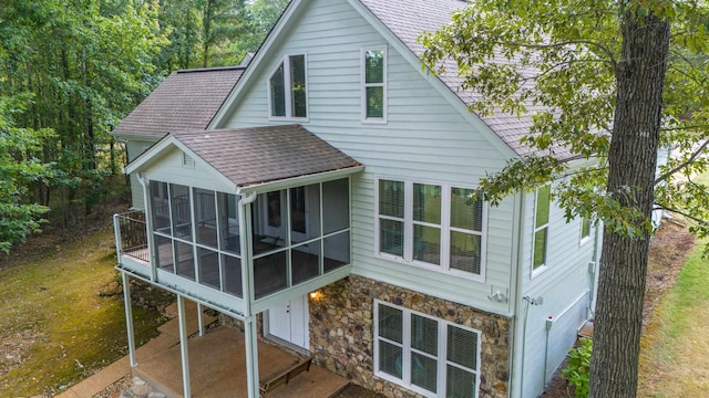 100 Vantage Pt, Counce, TN 38326 - back of house featuring stone siding, a shingled roof, and a sunroom