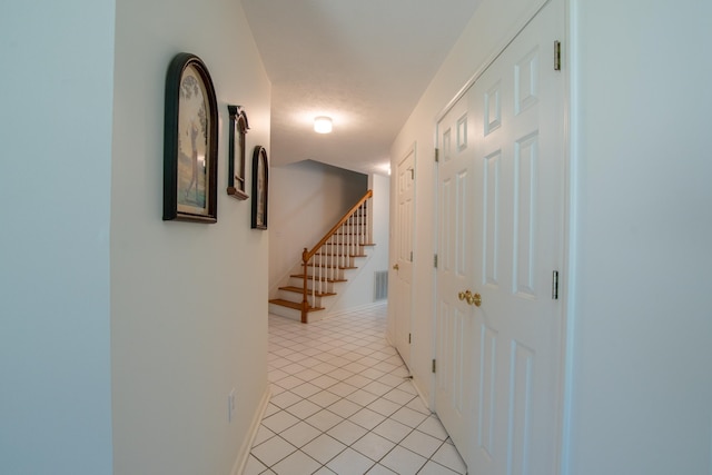 hallway featuring light tile patterned flooring