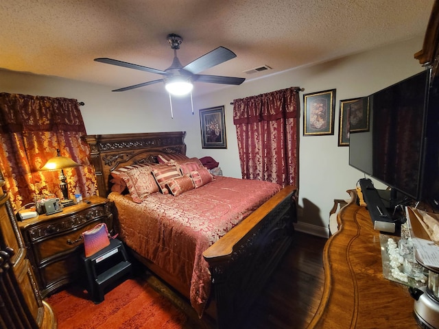 bedroom with ceiling fan, a textured ceiling, and hardwood / wood-style floors