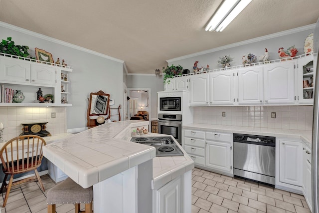 kitchen with light tile patterned floors, stainless steel appliances, decorative backsplash, and tile counters