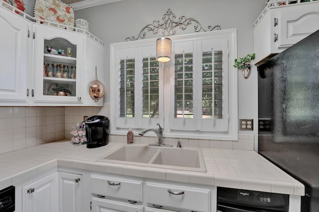 kitchen with backsplash, tile countertops, and white cabinets