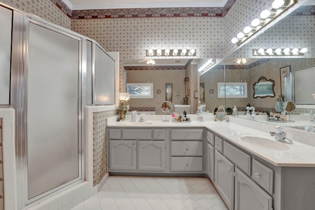 bathroom with dual vanity, crown molding, an enclosed shower, and tile patterned floors