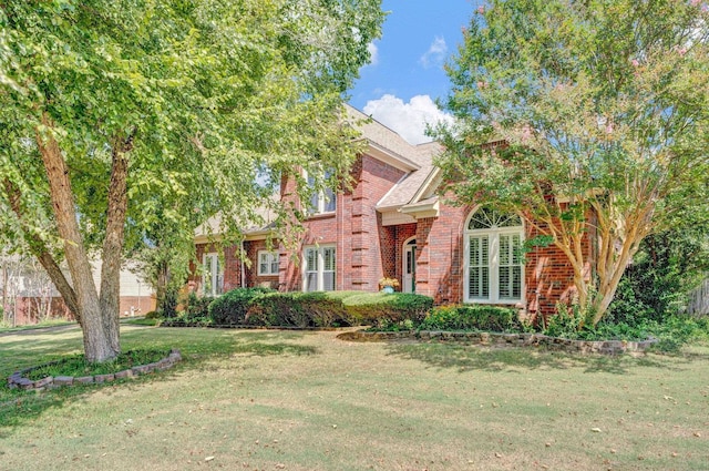 obstructed view of property with a front yard