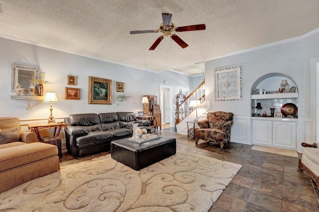 living room featuring ceiling fan, crown molding, and a textured ceiling