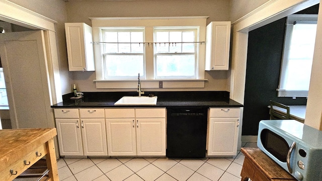 kitchen with black dishwasher, white cabinets, and a healthy amount of sunlight