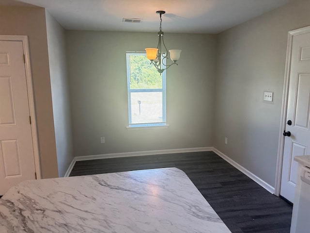 interior space featuring dark hardwood / wood-style flooring and a notable chandelier