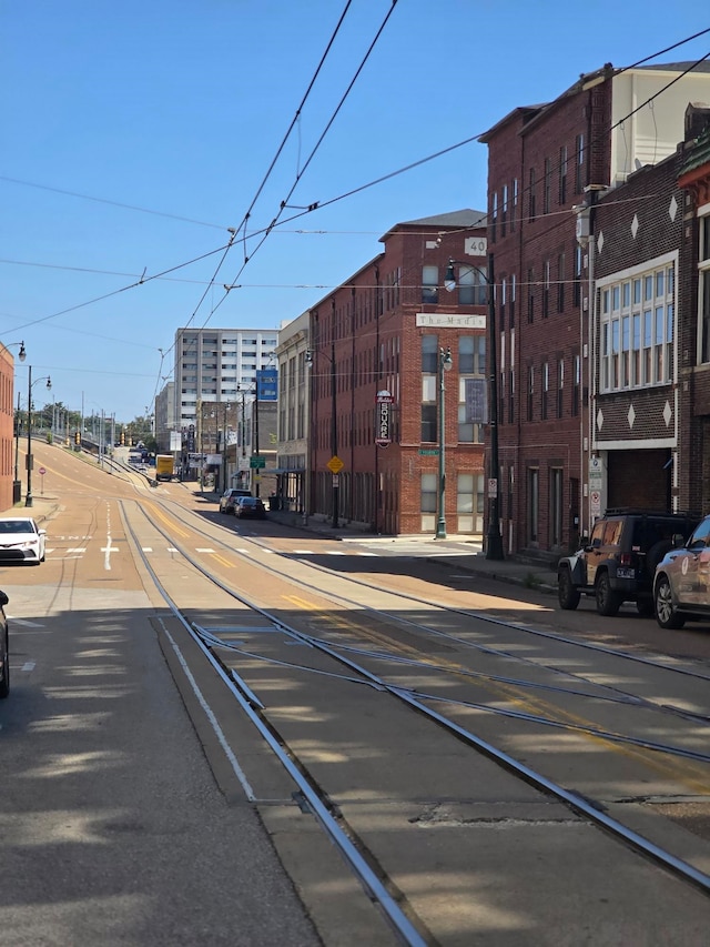 view of street with sidewalks, street lighting, and curbs