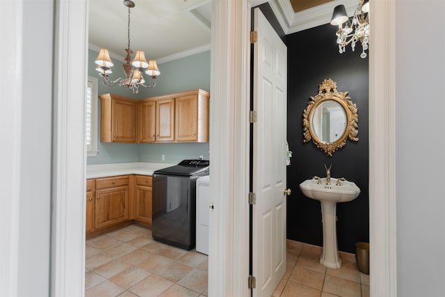 clothes washing area featuring an inviting chandelier, cabinets, light tile patterned floors, crown molding, and independent washer and dryer