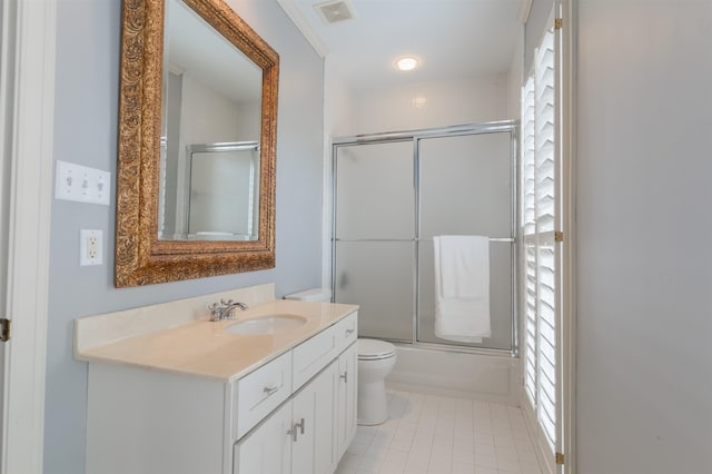 full bathroom with ornamental molding, tile patterned floors, enclosed tub / shower combo, vanity, and toilet