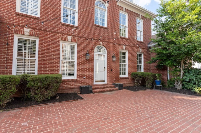 view of exterior entry featuring a patio