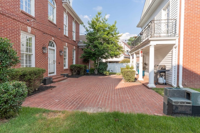 view of patio with grilling area and a balcony