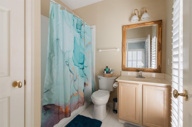 bathroom featuring tile patterned flooring, toilet, and vanity