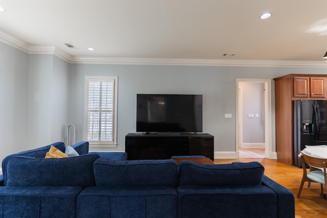 living room with ornamental molding and light wood-type flooring