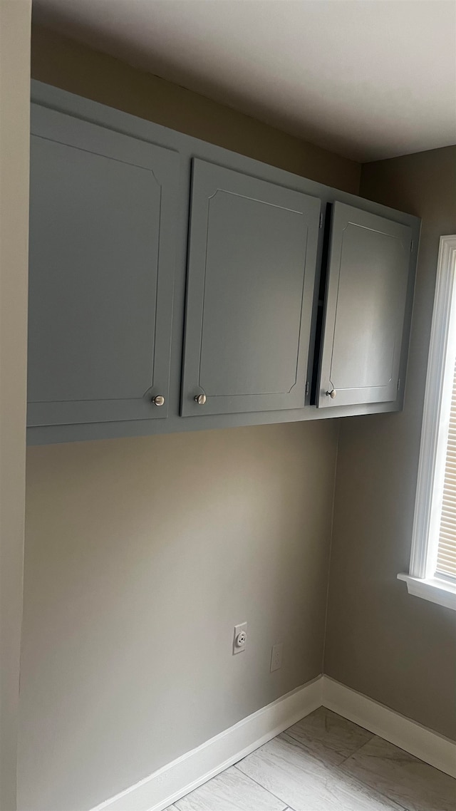 laundry area with light wood-type flooring