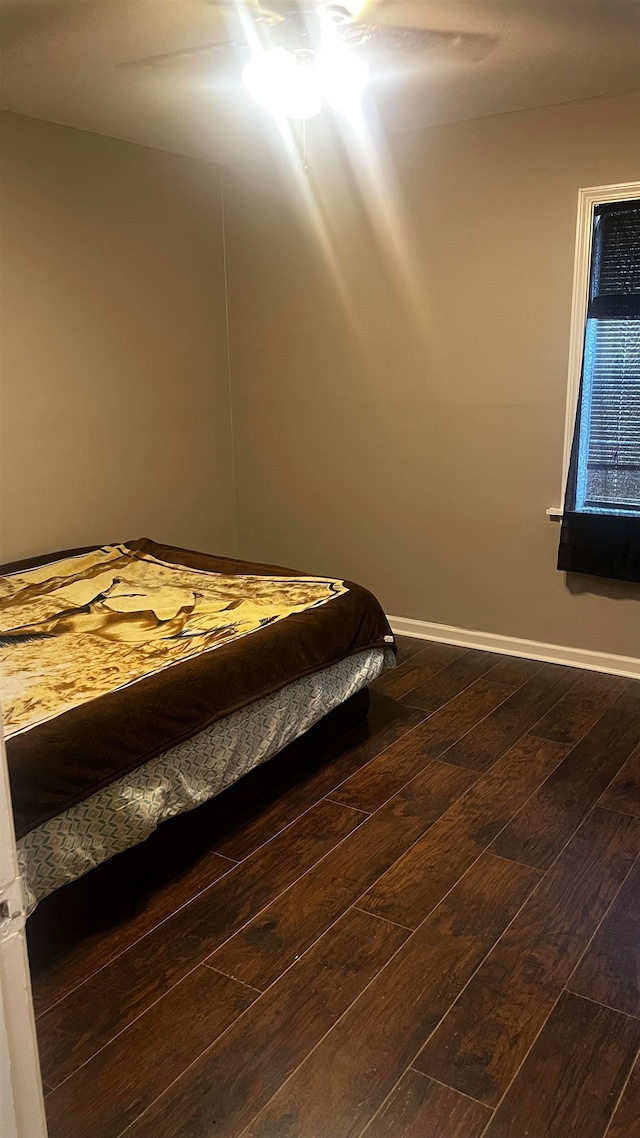 unfurnished bedroom featuring hardwood / wood-style floors and ceiling fan