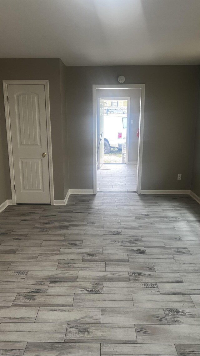 empty room featuring baseboards and wood finished floors