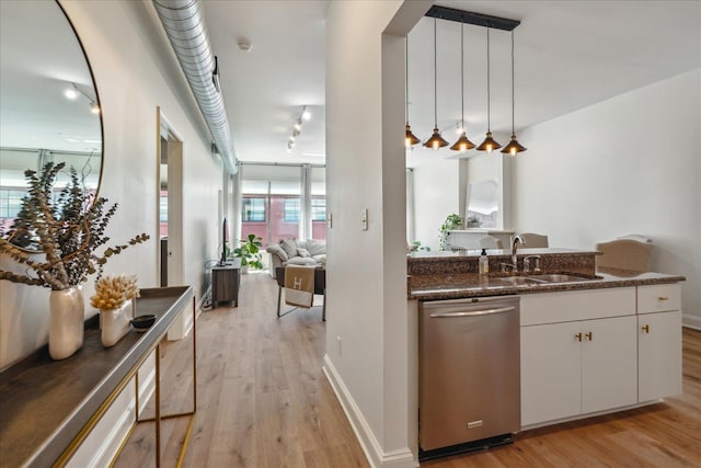 interior space with sink, white cabinets, stainless steel dishwasher, and light hardwood / wood-style flooring