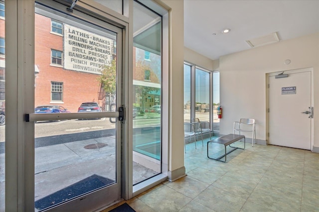 doorway with light tile patterned floors