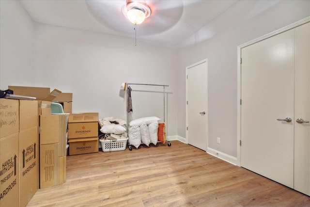 bedroom with ceiling fan, a closet, and light hardwood / wood-style flooring