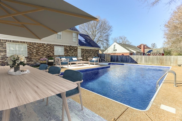 view of swimming pool featuring a fenced in pool, a patio area, a fenced backyard, and an outdoor hangout area