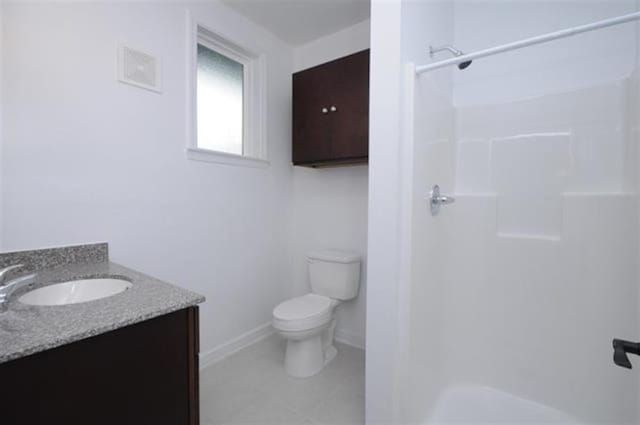 full bathroom with vanity, toilet, walk in shower, tile patterned floors, and baseboards
