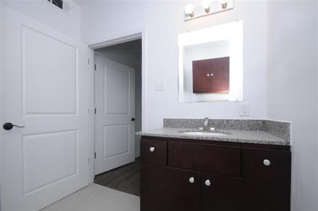 bathroom featuring vanity and hardwood / wood-style floors