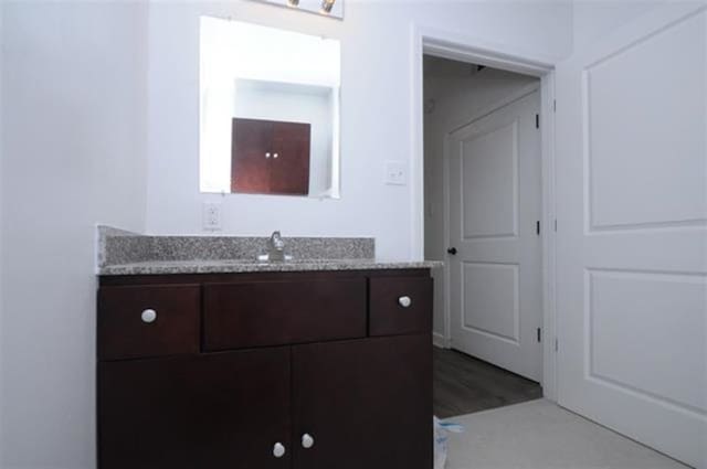 bathroom with hardwood / wood-style floors and vanity