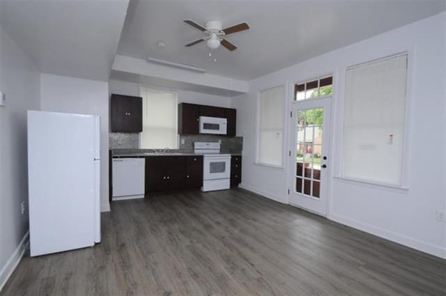 kitchen with baseboards, dark wood-style flooring, ceiling fan, white appliances, and backsplash