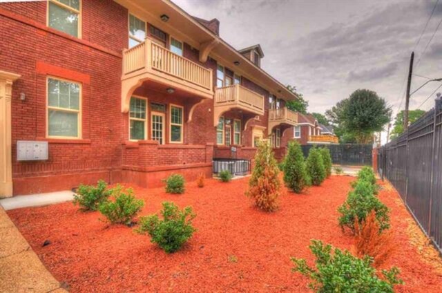 exterior space with brick siding and fence