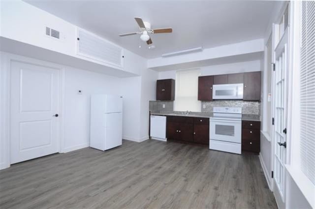 kitchen featuring decorative backsplash, dark brown cabinetry, white appliances, ceiling fan, and hardwood / wood-style flooring