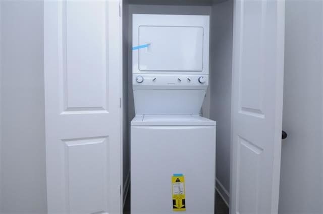 washroom featuring laundry area and stacked washer and clothes dryer