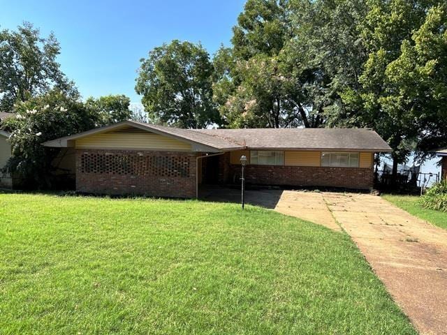 ranch-style home with brick siding and a front yard