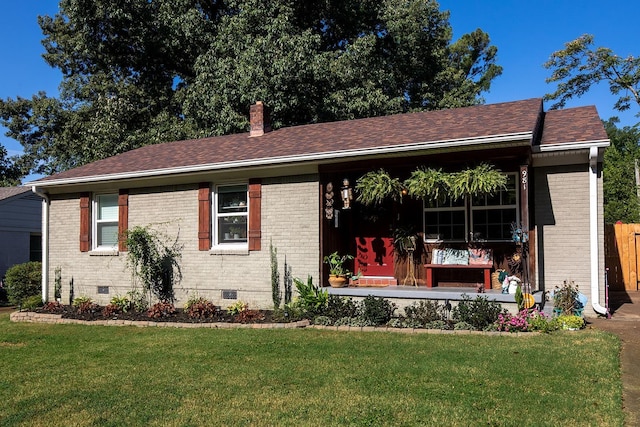 ranch-style home featuring brick siding, crawl space, a chimney, and a front yard